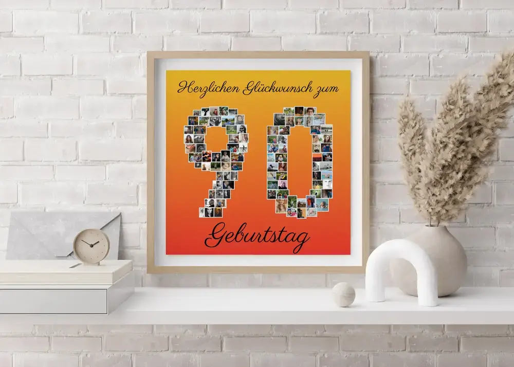 Fotocollage Zahl 90 mit gelb-rotem Farbverlauf im hellen Rahmen über einem weißen Sideboard vor einer Backsteinwand